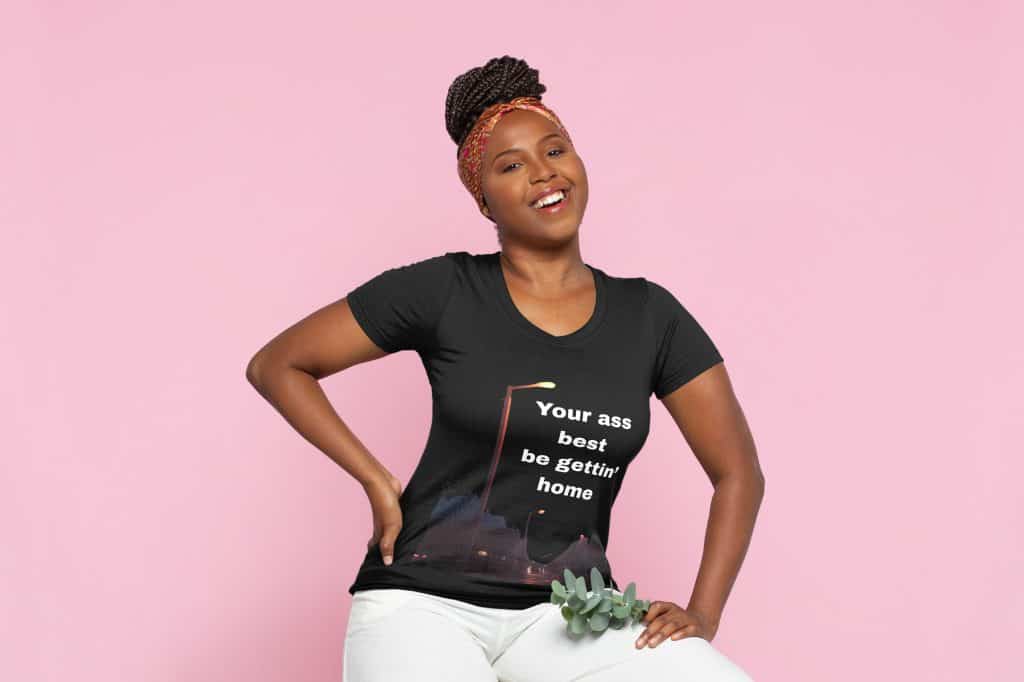 Woman wearing Cousins Dozens T-shirt with humorous quote on pink background.