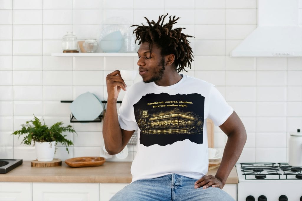 Young man drinking coffee in a modern kitchen, casual and relaxed vibe.