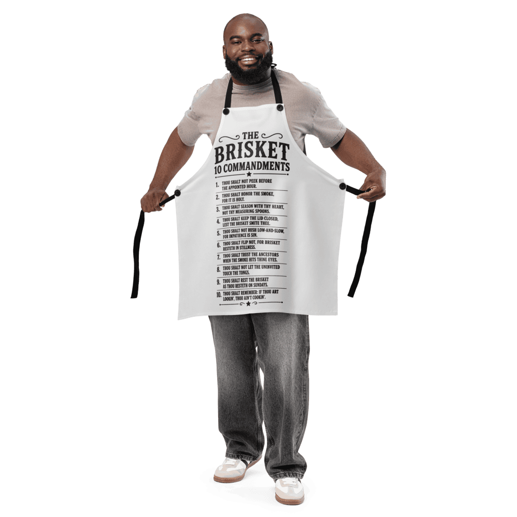 Man smiling wearing a Brisket 10 Commandments apron for barbecue.
