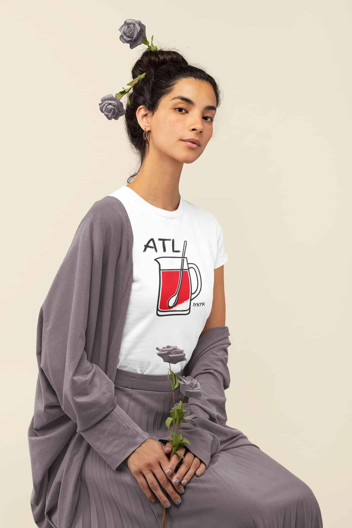 Young couple holding hands, wearing Cousins Dozens ATL T-shirt, smiling together.