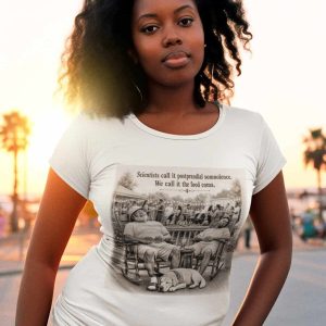 Young woman with curly hair wearing a white graphic t-shirt at sunset outdoor setting.