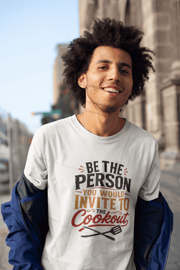 Young man smiling outdoors wearing a casual t-shirt with motivational quote about being the person o.